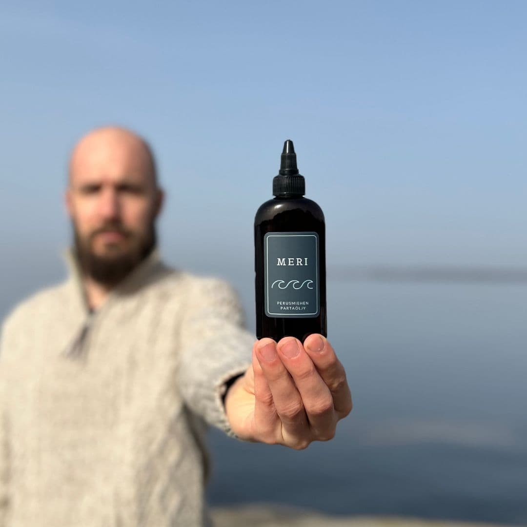 Beard oil product with person holding bottle